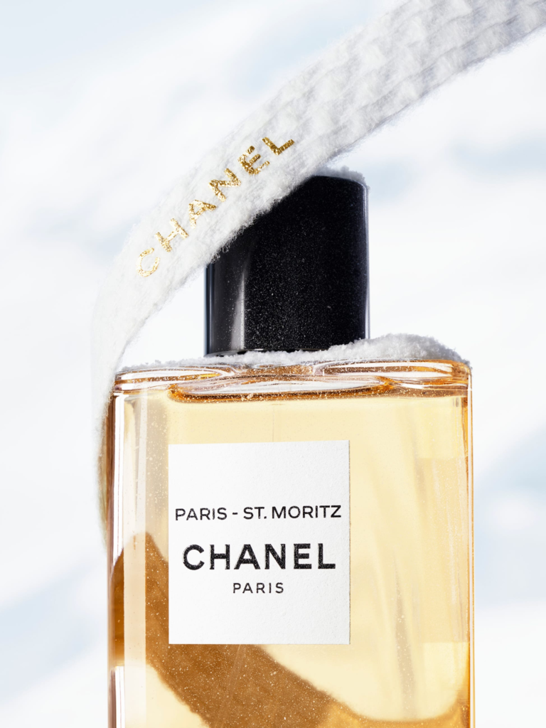 Chanel Paris–St. Moritz perfume bottle in a snowy winter setting