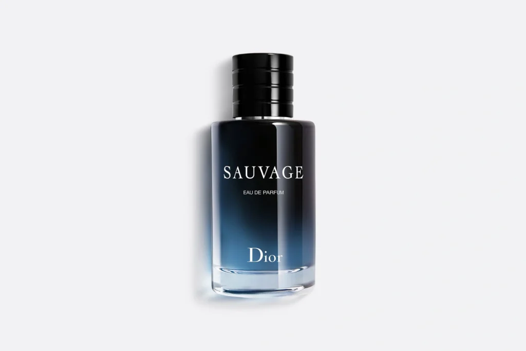 Dior Sauvage Eau de Parfum fragrance bottle with dark blue gradient glass, black cylindrical cap and Eau de Parfum lettering.