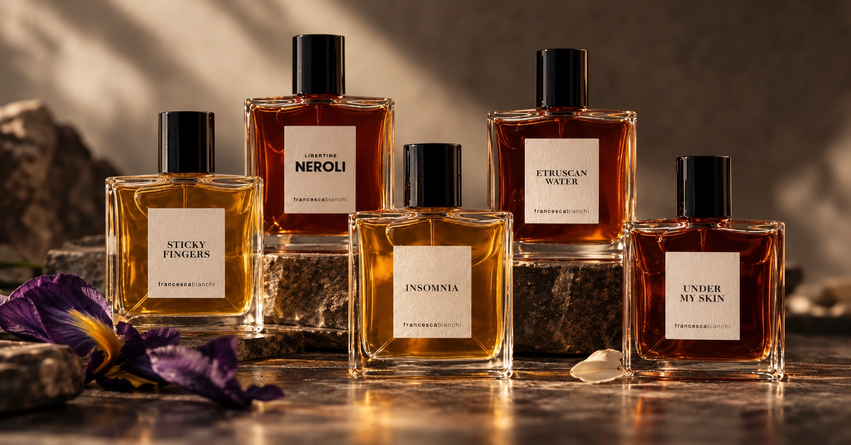 Five Francesca Bianchi perfume bottles in a warm editorial composition