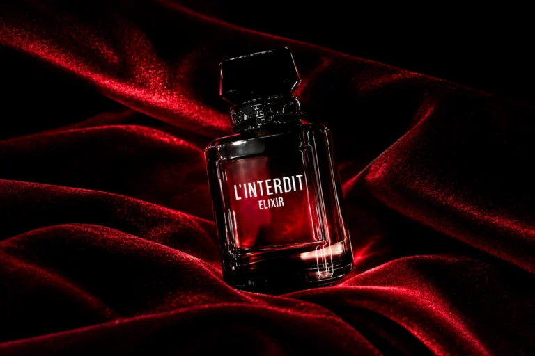 Givenchy L’Interdit Elixir perfume bottle on luxurious red velvet with dramatic dark lighting