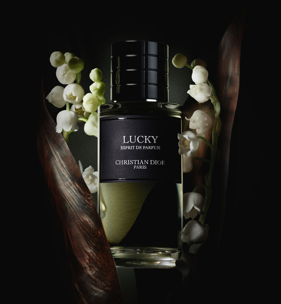 Lucky Esprit de Parfum bottle with white lily of the valley flowers