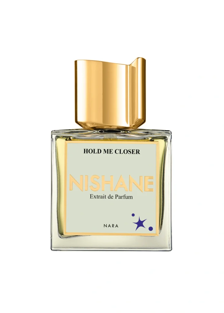 Nishane Hold Me Closer Extrait de Parfum bottle featuring a sculptural gold cap, pale label and NARA graphic detail.
