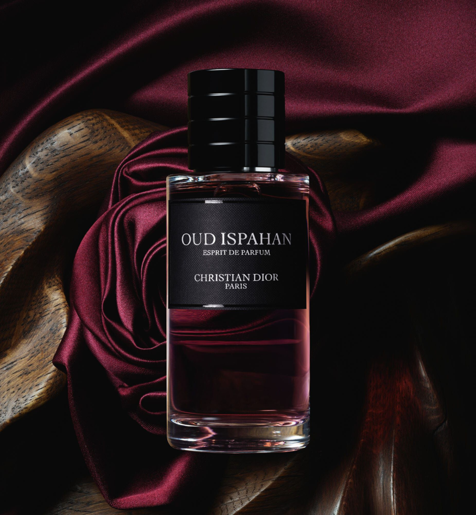 Oud Ispahan Esprit de Parfum bottle with burgundy fabric background