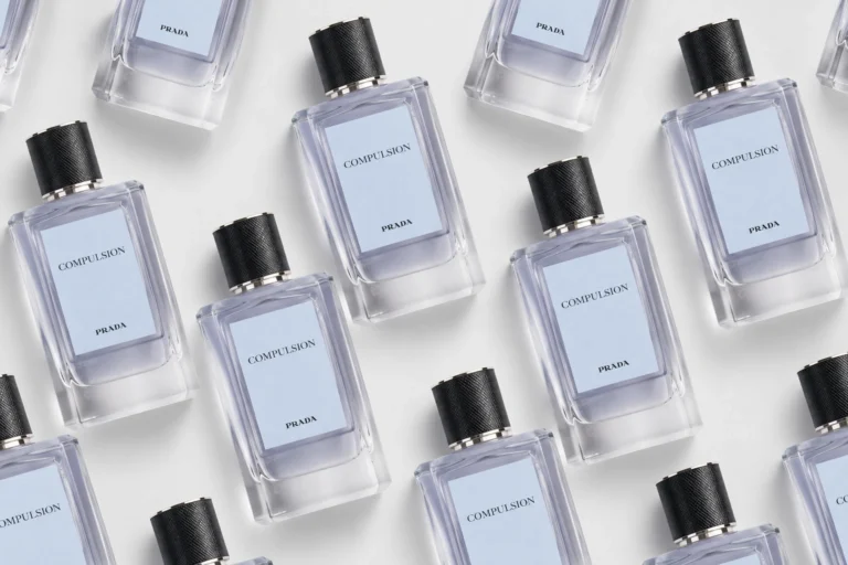 Prada Compulsion Eau de Parfum bottles arranged in a diagonal pattern for an editorial fragrance cover.