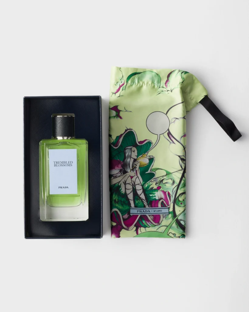 Prada Trembled Blossoms Eau de Parfum presented in its black box alongside a colourful Prada patterned silk pouch.