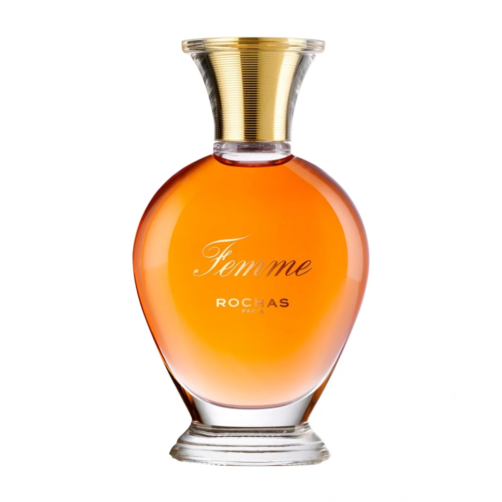 Rochas Femme Eau de Toilette in its rounded amber-colored bottle with a sculptural golden cap.