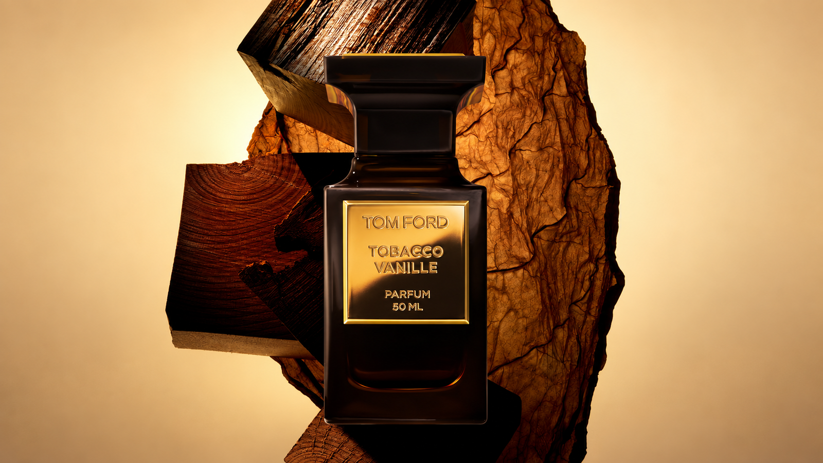 Tom Ford Tobacco Vanille Parfum bottle against wood and tobacco leaves